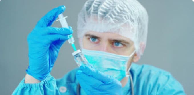 A doctor looking at an injectable needle