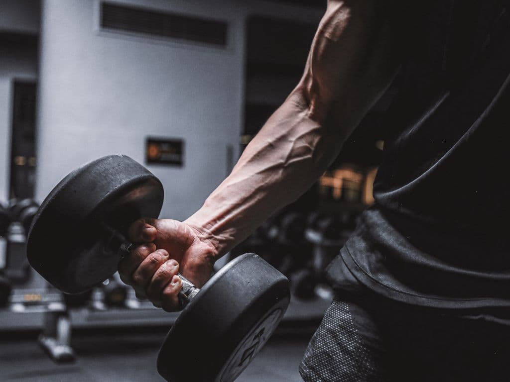 A man's arm lifting a heavy weight