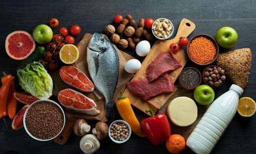 A charcuterie board with myriad fruit, meat, grains, fish, mushrooms, and eggs.