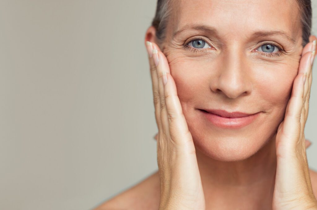 close up of a senior womans face smiling and having perfect skin demonstrating the GHK-Cu offering from Vita Bella