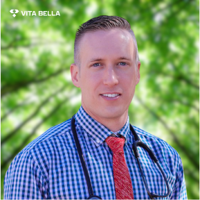 Dr. Lieske, Chief Medical Officer at Vita Bella, wearing a checkered shirt, red tie, and stethoscope, with a green background